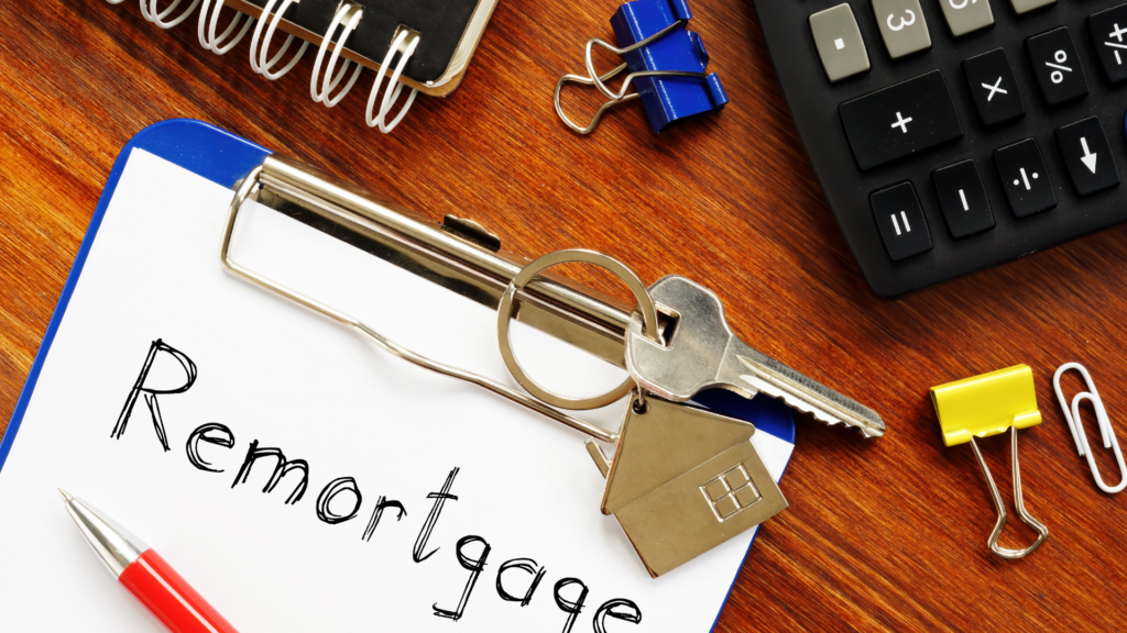 A professional desk setup with a model house, calculator, and financial documents, representing strategic planning in remortgaging a Help to Buy home.