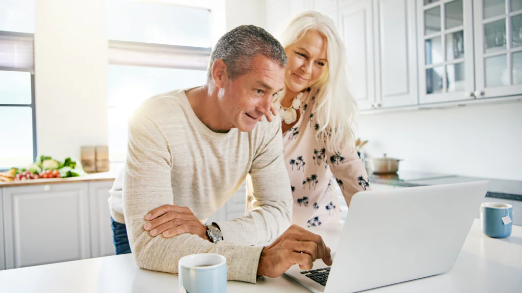 Senior couple exploring home renovation plans and travel options, symbolizing the opportunities afforded by a lifetime mortgage.