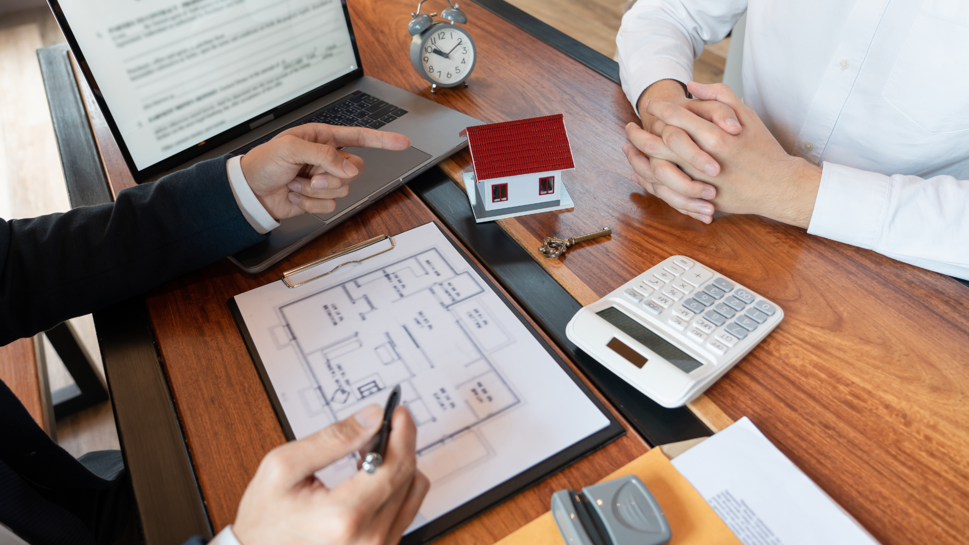 A remortgage broker shaking hands with a client in front of a home, with a clipboard and model house, symbolising professional assistance in the remortgaging process.